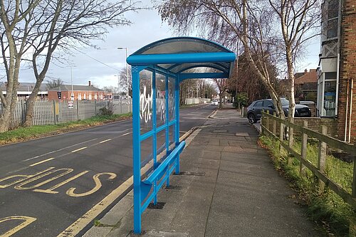 Bus stop and shelter with graffiti tag